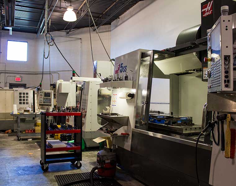 CNC machine shop with CNC lathe and multiple CNC mills